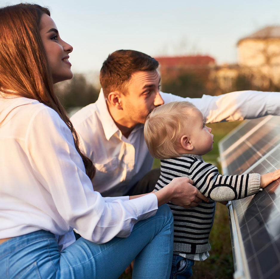 Generational family with newborn admiring solar farm